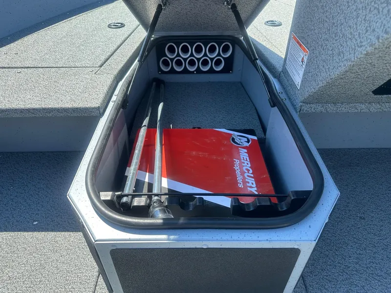 Slide: The Image of Open storage compartment in 2025 Lund Adventure 1675 SS boat with Mercury propeller box. - 11