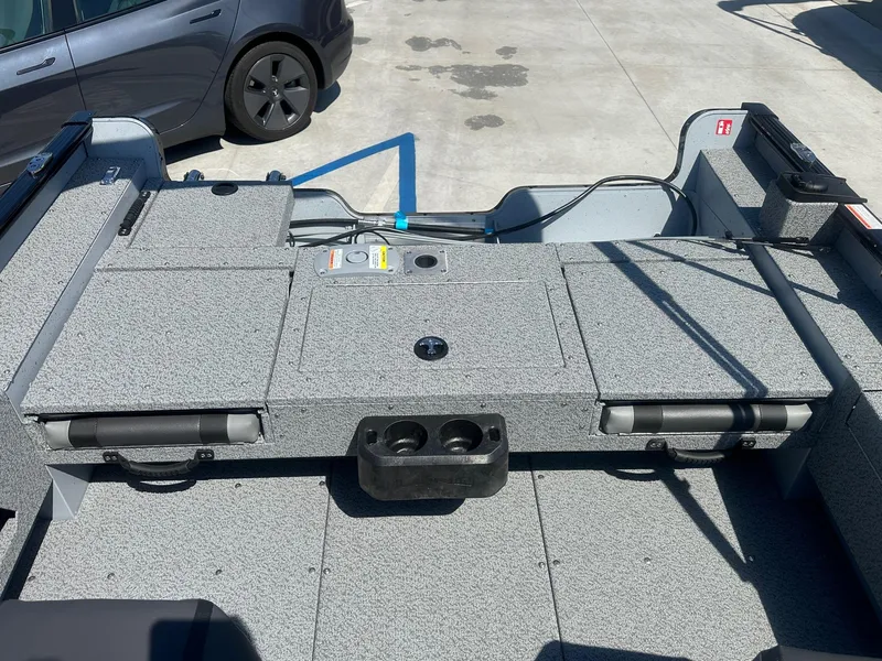 Slide: The Image of 2025 Lund Adventure 1675 SS boat interior with storage compartments and cup holders. - 13