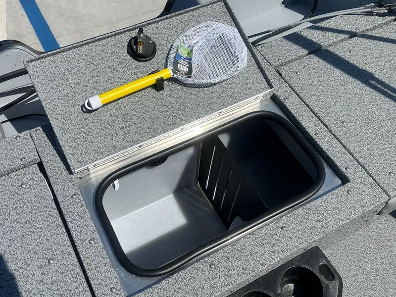 Slide: The Image of 2025 Lund Adventure 1675 SS boat with open storage compartment and fishing net. - 14