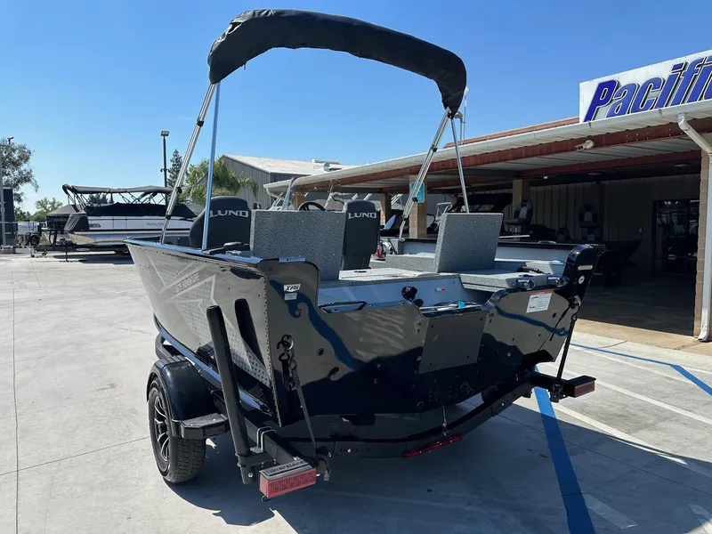 Slide: The Image of 2025 Lund Adventure 1675 SS boat with 90HP Mercury engine, parked outdoors. - 8