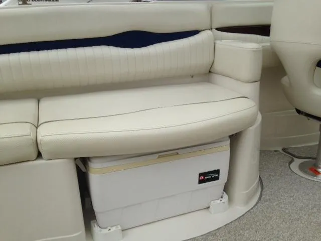 Slide: The Image of 2005 Monterey MONTURA 248 LS boat interior with white seating and built-in cooler storage. - 10
