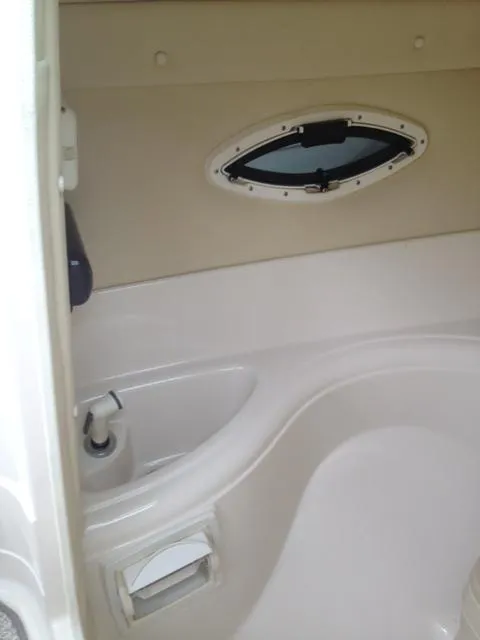 Slide: The Image of Interior of 2005 Monterey MONTURA 248 LS boat with porthole and seating area. - 17