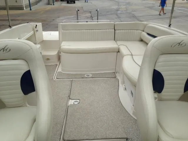 Slide: The Image of 2005 Monterey MONTURA 248 LS boat interior with white seating and carpeted floor. - 18