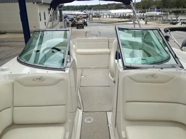 Slide: The Image of 2005 Monterey MONTURA 248 LS boat interior with beige seating and open deck. - 20