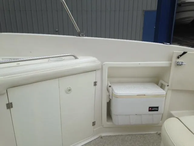 Slide: The Image of 2005 Monterey MONTURA 248 LS boat interior with storage compartments and cooler. - 21