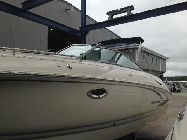 Slide: The Image of 2005 Monterey MONTURA 248 LS boat docked near a building under cloudy skies. - 27