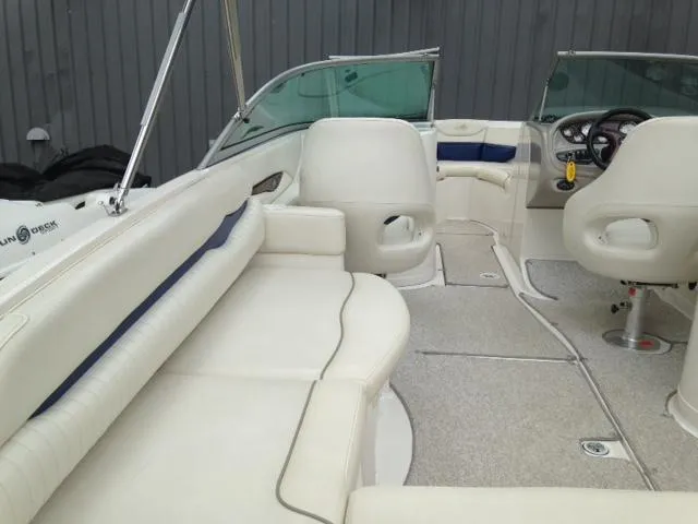 Slide: The Image of 2005 Monterey MONTURA 248 LS boat interior with white seating and steering console. - 7