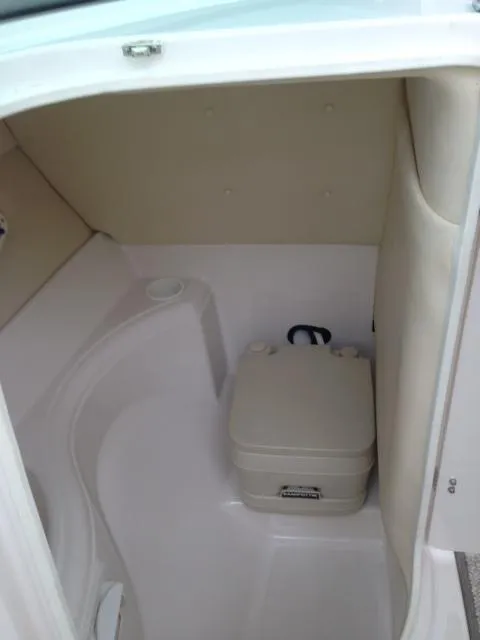 Slide: The Image of 2005 Monterey MONTURA 248 LS boat interior with compact portable toilet. - 8