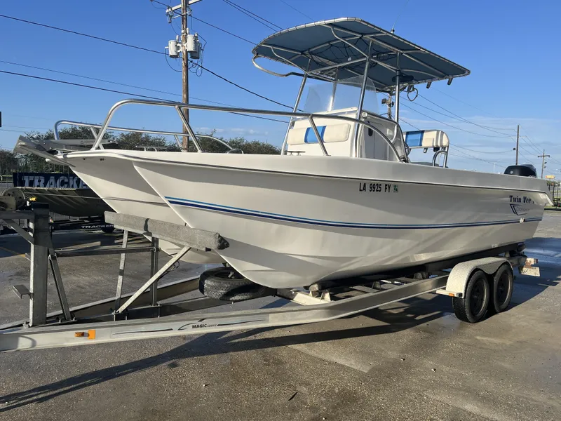 Slide: The Image of 2012 Twin Vee Ocean Cat 22 boat on trailer, parked outdoors. - 10