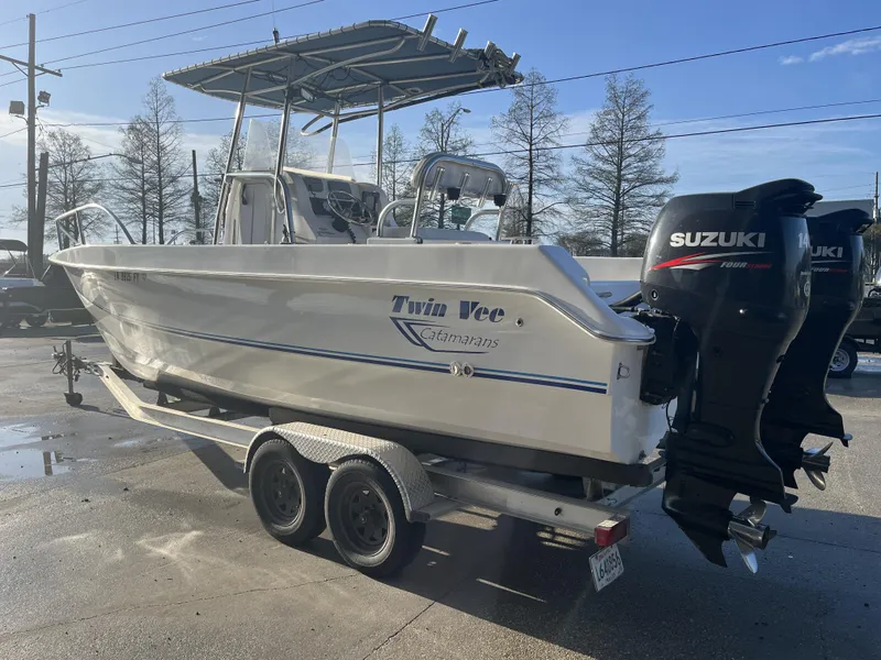 Slide: The Image of 2012 Twin Vee Ocean Cat 22 boat on trailer with Suzuki outboard motors. - 11