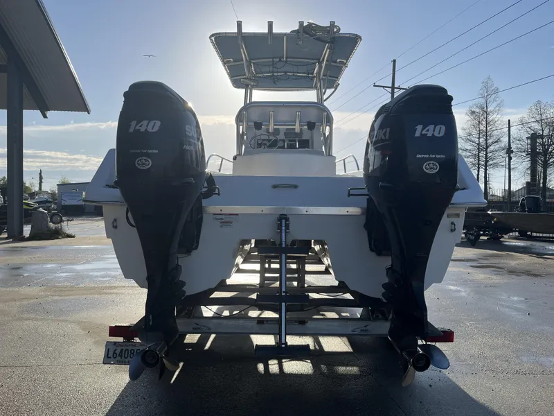 Slide: The Image of 2012 Twin Vee Ocean Cat 22 with dual Suzuki 140 engines, rear view in sunlight. - 12