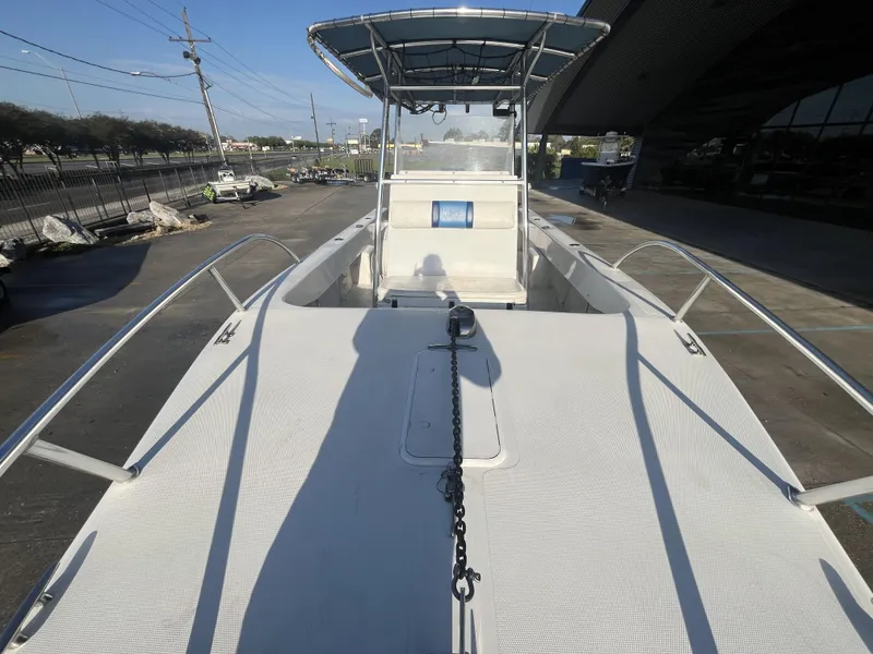 Slide: The Image of 2012 Twin Vee Ocean Cat 22 boat, docked, with spacious deck and canopy. - 14
