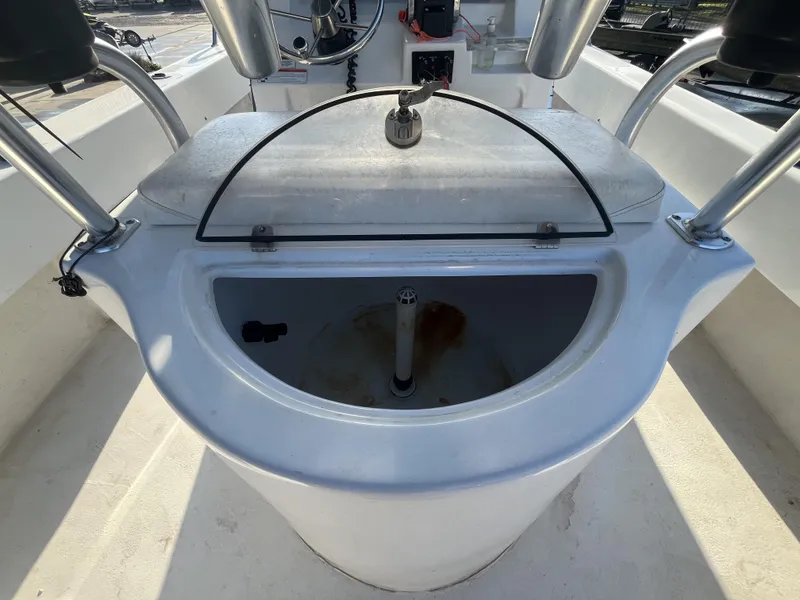 Slide: The Image of 2012 Twin Vee Ocean Cat 22 boat console with storage compartment and steering controls. - 16