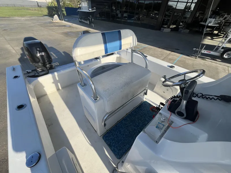 Slide: The Image of 2012 Twin Vee Ocean Cat 22 boat interior with steering wheel and seating. - 17