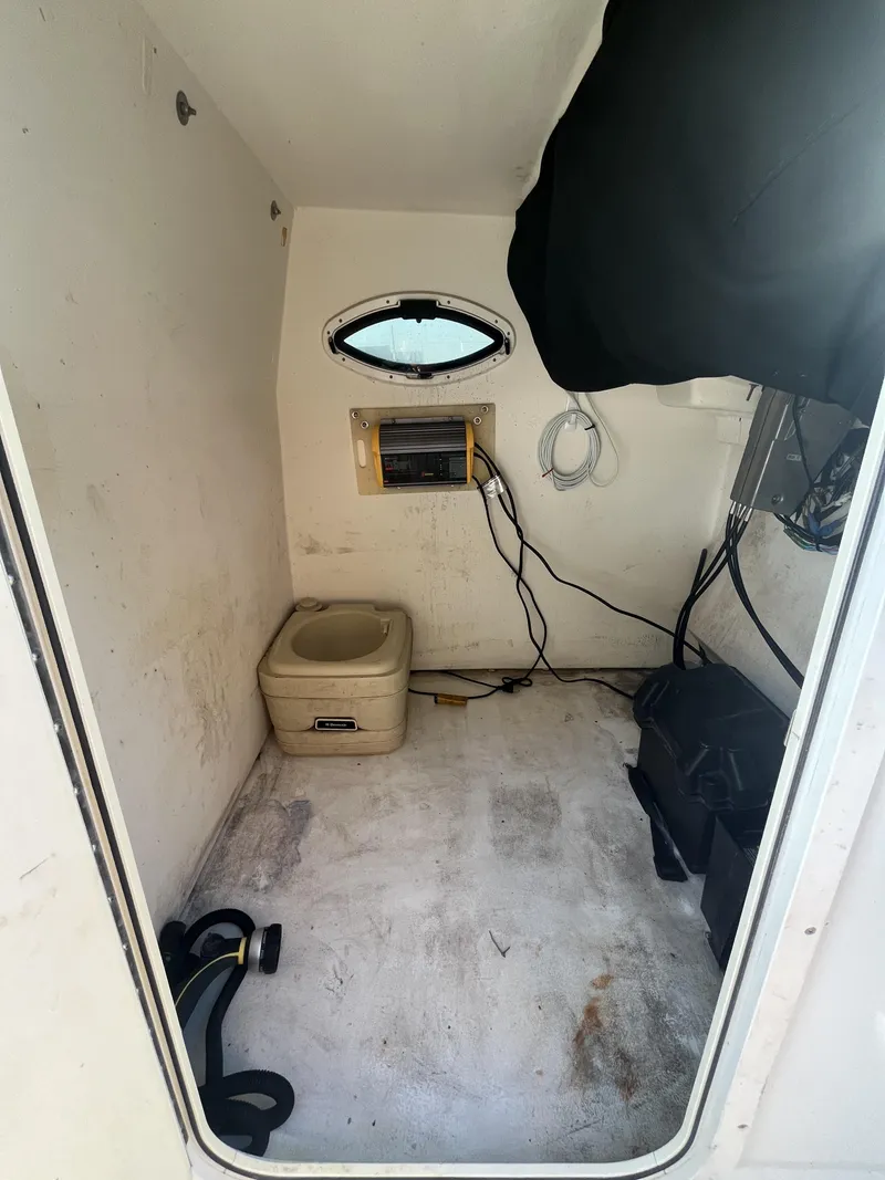 Slide: The Image of Interior of a 2012 Twin Vee Ocean Cat 22 boat cabin with portable toilet. - 8