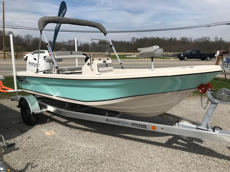 Slide: The Image of 2025 Carolina Skiff 178 JLS boat on trailer, light blue hull, parked outdoors. - 0