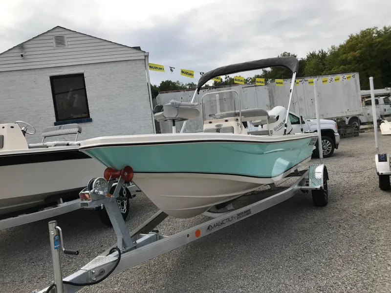 Slide: The Image of 2025 Carolina Skiff 178 JLS boat on trailer, displayed outdoors. - 12