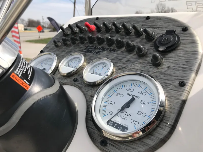 Slide: The Image of Dashboard of 2025 Carolina Skiff 178 JLS boat with gauges and controls. - 7