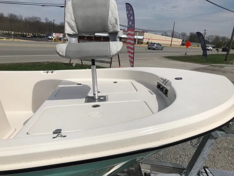 Slide: The Image of 2025 Carolina Skiff 178 JLS boat with elevated seat, displayed outdoors. - 8