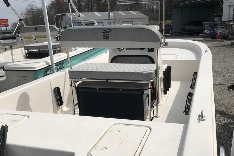 Slide: The Image of 2025 Carolina Skiff E18 JVX CC boat interior with seating and storage compartments. - 6