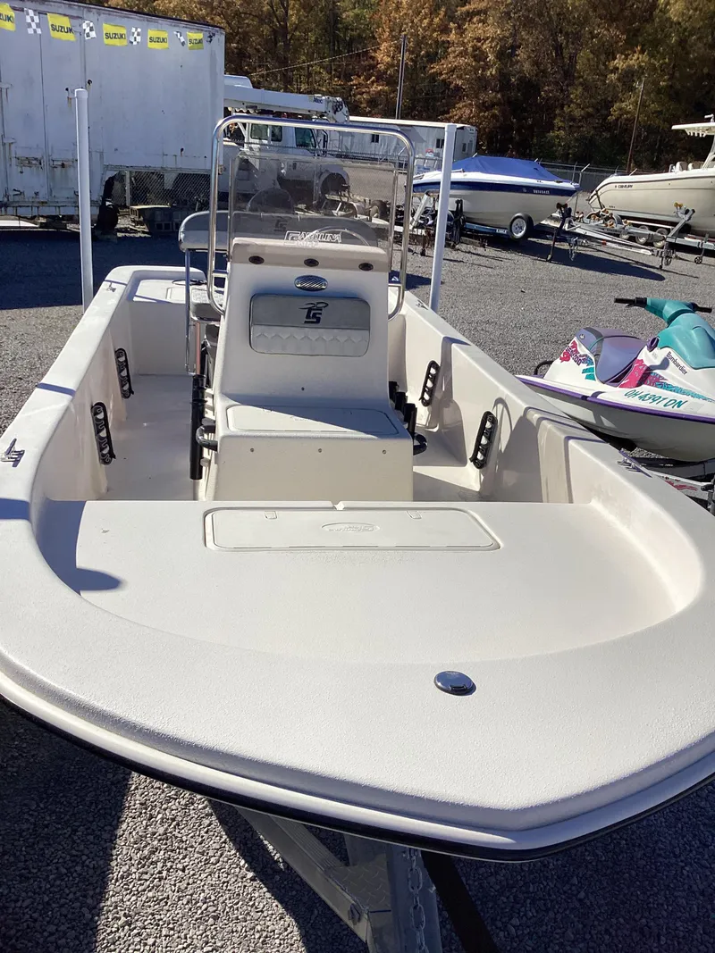 Slide: The Image of 2025 Carolina Skiff E18 JVX CC boat, center console, parked outdoors. - 7