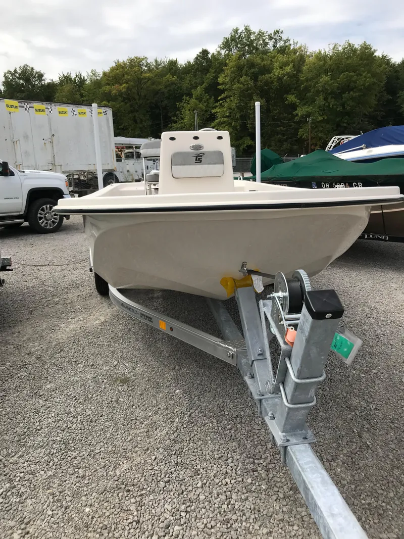 Slide: The Image of 2025 Carolina Skiff E18 JVX CC boat on trailer, parked outdoors. - 8