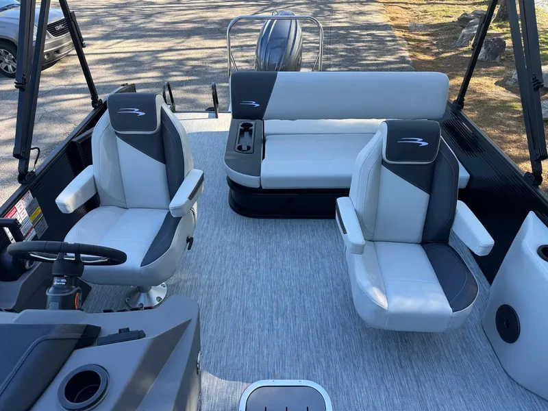 Slide: The Image of 2025 Bennington 22SSB pontoon boat interior with modern seating and steering console. - 10
