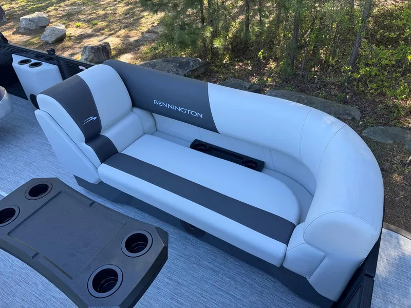 Slide: The Image of Luxurious seating on 2025 Bennington 22SSB pontoon boat with cup holders and sleek design. - 16