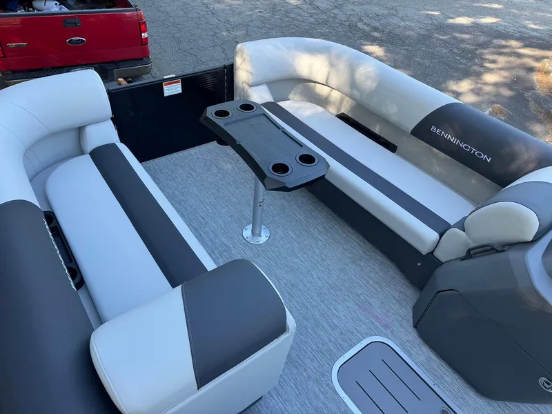 Slide: The Image of 2025 Bennington 22SSB pontoon boat interior with seating and table. - 8