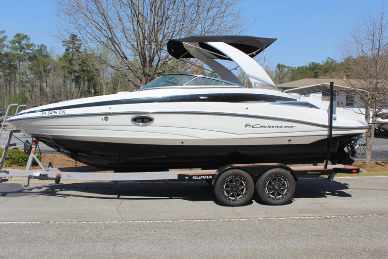 Slide: The Image of 2018 Crownline 255 SS boat on trailer, parked outdoors. - 1