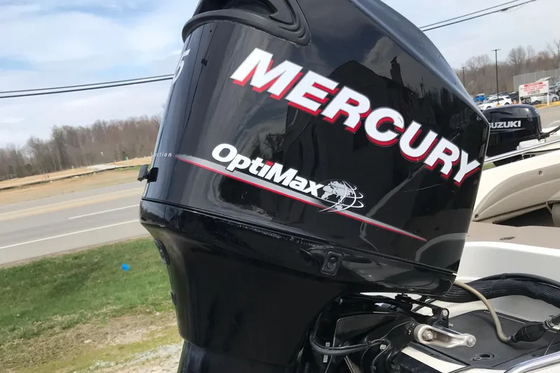 Slide: The Image of Mercury OptiMax engine on 2013 Ranger 186 Reata boat, parked near a road. - 10