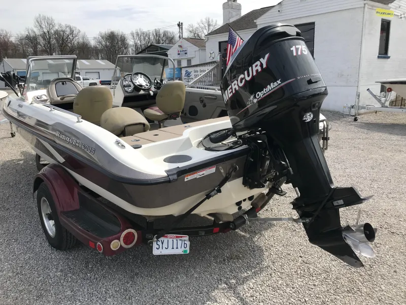 Slide: The Image of 2013 Ranger 186 Reata boat with Mercury 175 engine, parked on gravel. - 4