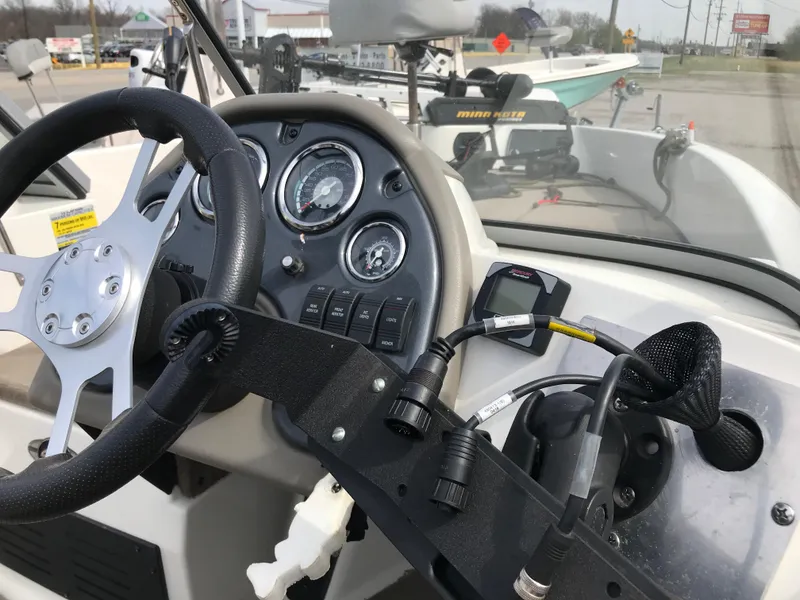 Slide: The Image of 2013 Ranger 186 Reata boat dashboard with steering wheel and control panel. - 6