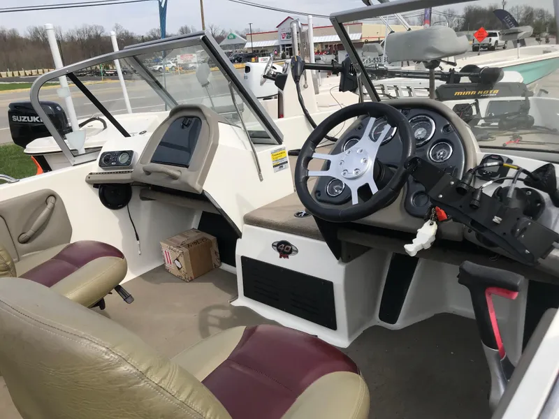 Slide: The Image of Interior of a 2013 Ranger 186 Reata boat with steering wheel and dashboard. - 7
