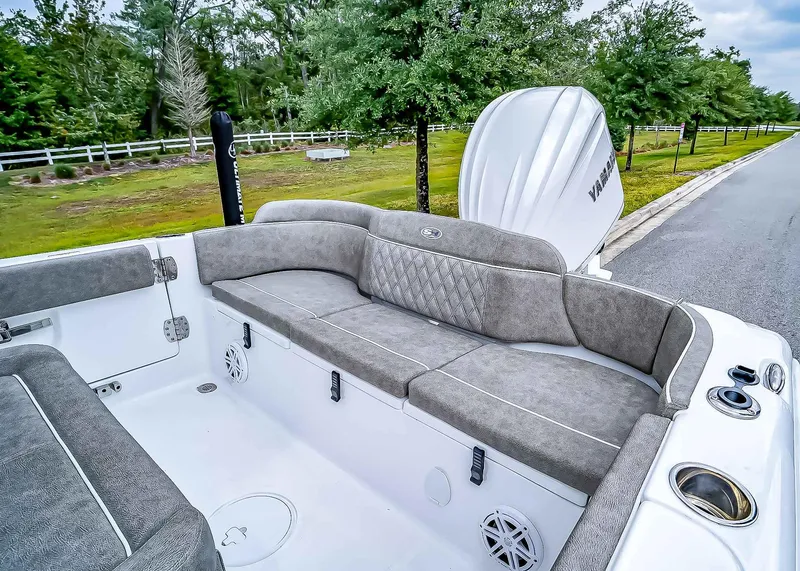 Slide: The Image of 2025 Sea Hunt Ultra 235 SE boat interior with cushioned seating and Yamaha engine. - 10