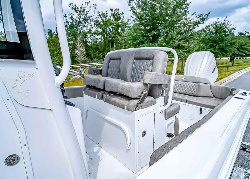 Slide: The Image of 2025 Sea Hunt Ultra 235 SE boat interior with cushioned seating and console. - 15