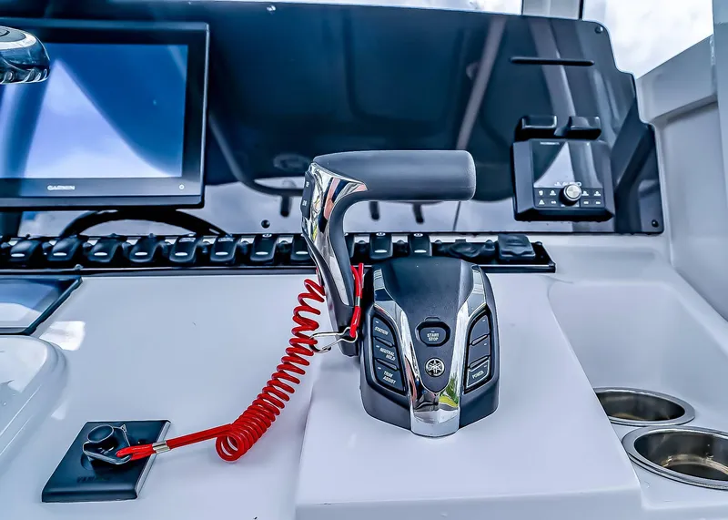 Slide: The Image of Control panel of 2025 Sea Hunt Ultra 235 SE boat with modern throttle and display. - 18