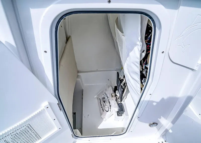 Slide: The Image of 2025 Sea Hunt Ultra 235 SE storage compartment with organized interior and equipment. - 19