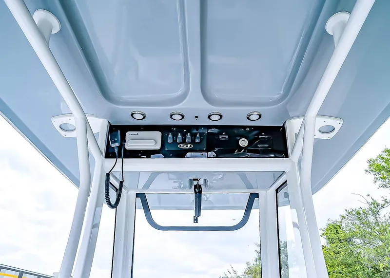 Slide: The Image of 2025 Sea Hunt Ultra 235 SE boat console with modern controls and navigation equipment. - 20