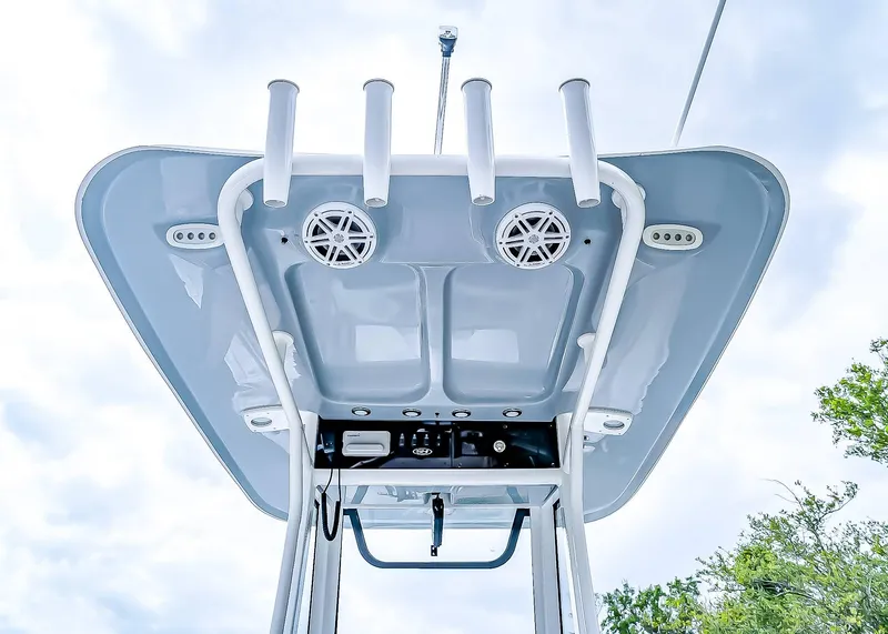 Slide: The Image of 2025 Sea Hunt Ultra 235 SE boat T-top with rod holders and speakers, viewed from below. - 21