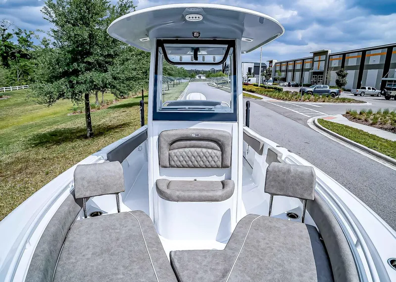 Slide: The Image of 2025 Sea Hunt Ultra 235 SE boat interior with cushioned seating and modern design. - 24