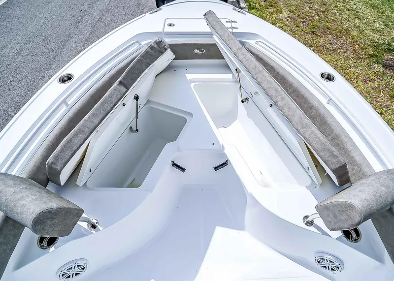 Slide: The Image of 2025 Sea Hunt Ultra 235 SE boat interior with open storage compartments and cushioned seating. - 26