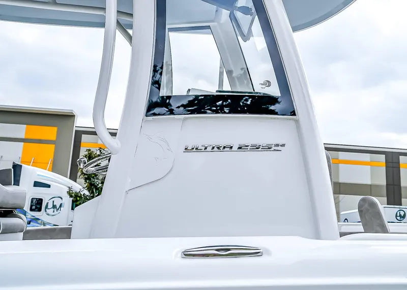 Slide: The Image of 2025 Sea Hunt Ultra 235 SE boat, sleek design, close-up view, modern facility background. - 7