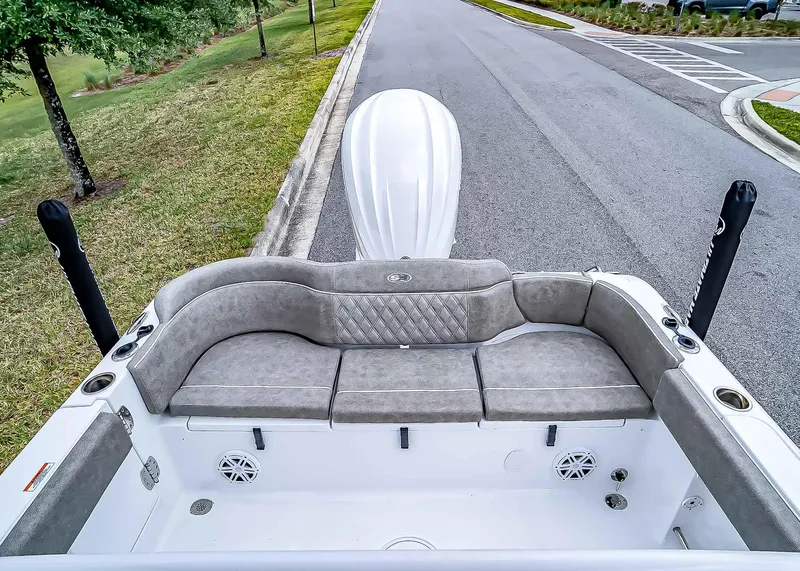 Slide: The Image of 2025 Sea Hunt Ultra 235 SE boat interior with cushioned seating and speakers. - 9