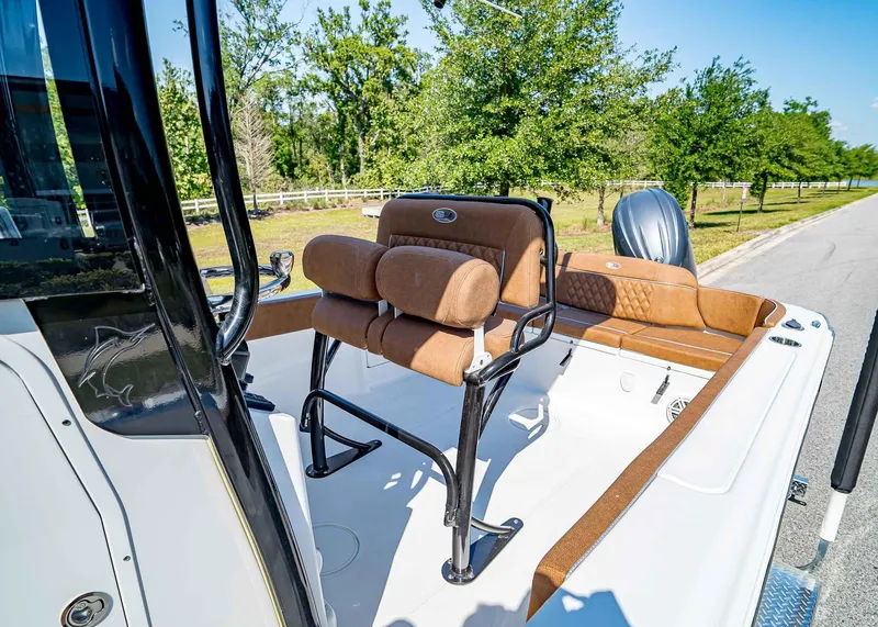Slide: The Image of 2025 Sea Hunt Ultra 235 SE boat interior with brown seating and sleek design. - 10