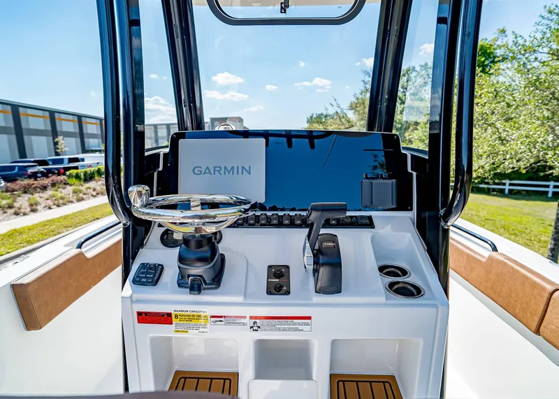 Slide: The Image of 2025 Sea Hunt Ultra 235 SE boat dashboard with Garmin navigation system. - 13