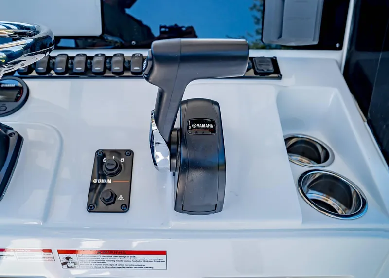 Slide: The Image of 2025 Sea Hunt Ultra 235 SE boat console with Yamaha controls and cup holders. - 14