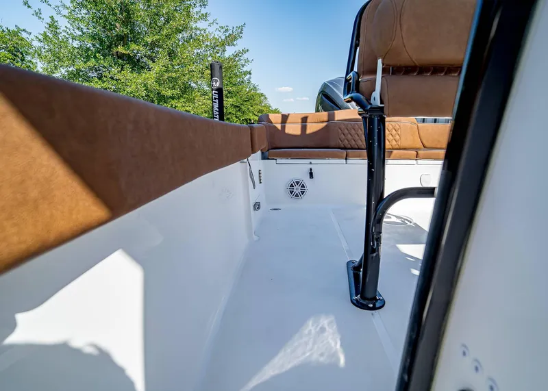 Slide: The Image of 2025 Sea Hunt Ultra 235 SE boat interior with brown seating and sleek design. - 18