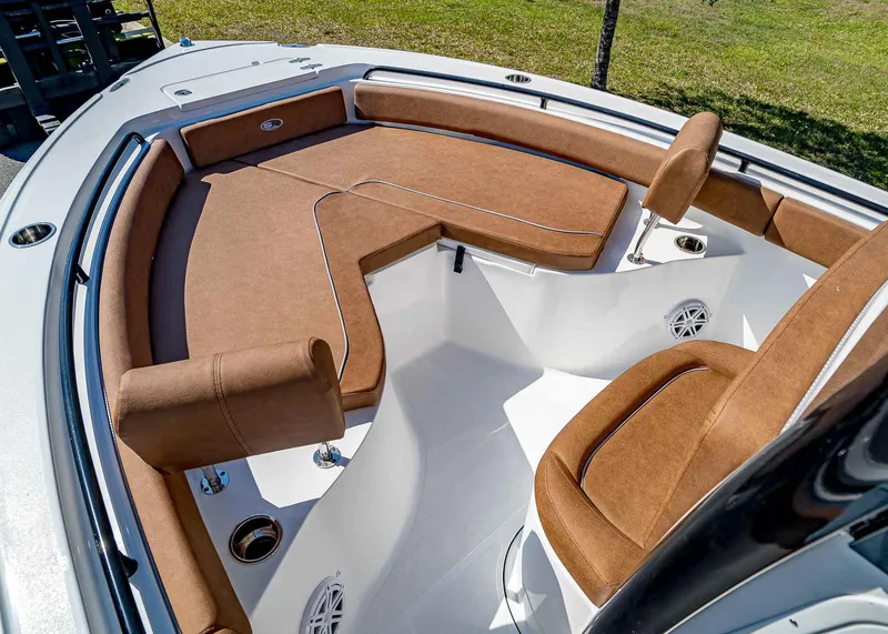 Slide: The Image of 2025 Sea Hunt Ultra 235 SE boat interior with brown cushioned seating. - 19