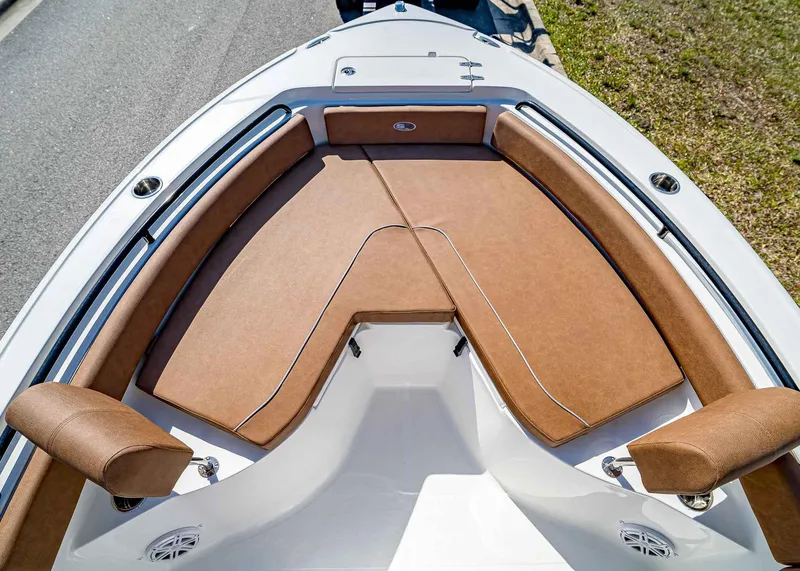 Slide: The Image of 2025 Sea Hunt Ultra 235 SE boat with brown cushioned seating and sleek design. - 20